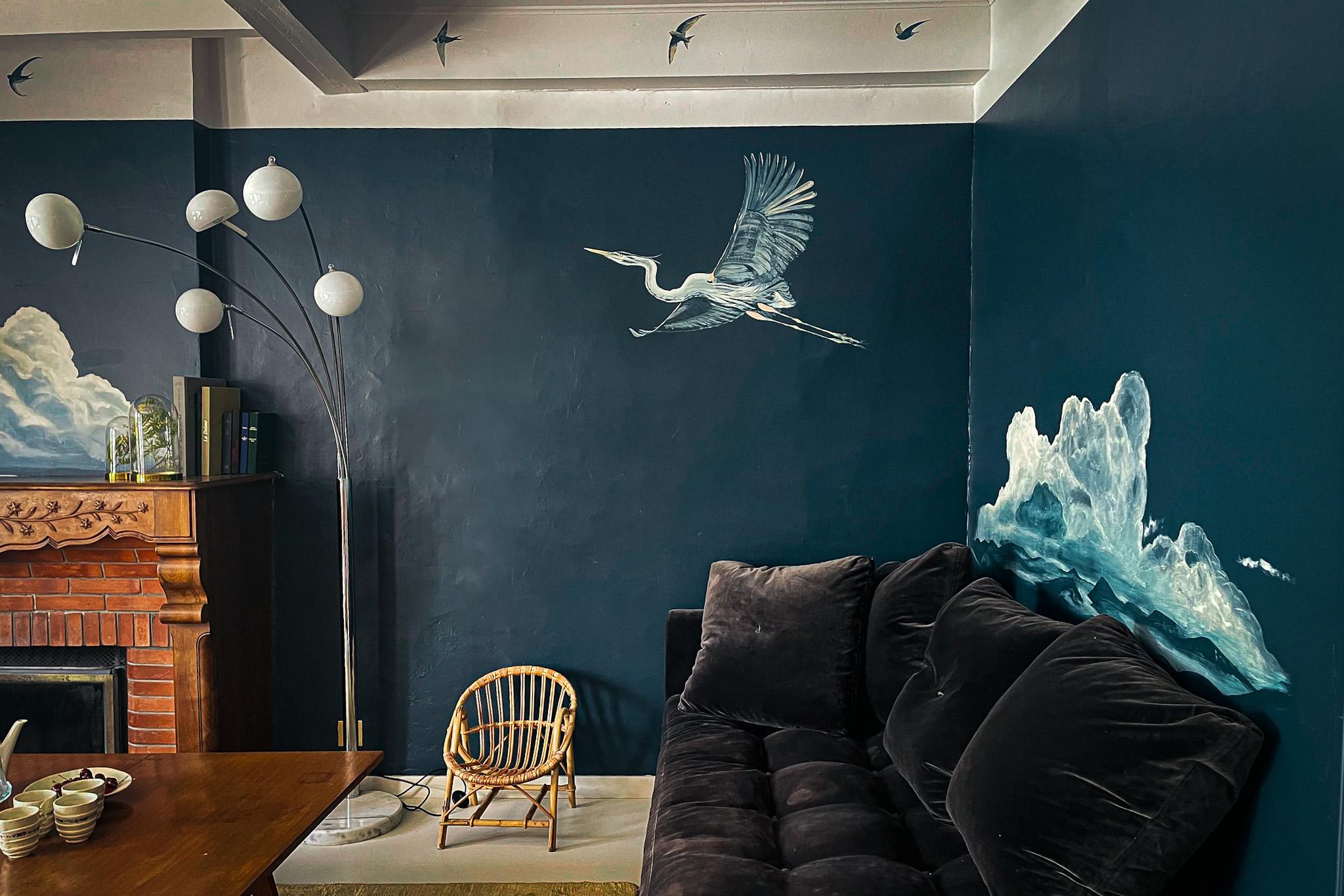 The mural by painter David Simonetta adorns the living room wall